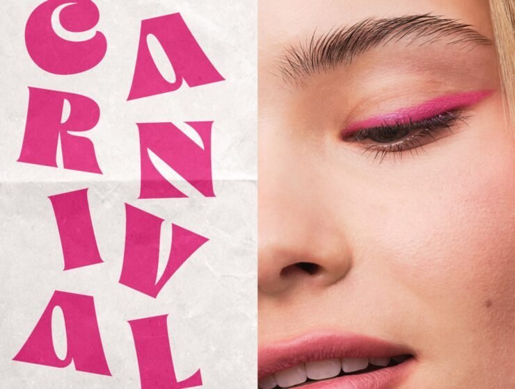 Close up of young woman's face wearing bright pink eyeliner next to poster with pink lettering advertising Harrods H Beauty Carnival
